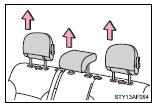 Pull the head restraint up while pushing the lock release button.