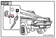 Open the tailgate to the angle where you can release the brackets on the support