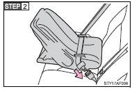 Run the seat belt through the child seat and insert the plate into the buckle.