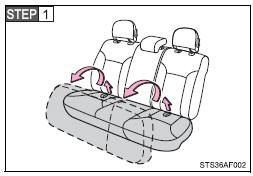 Swing the bottom cushion up by pulling the lock release strap.