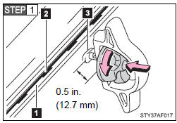 Loosen the thumb wheel in a counterclockwise motion, and depress the wheel so