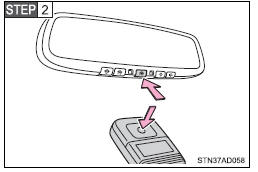 Press and hold down one of the buttons on the HomeLink® and the button on the