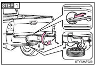 Insert the end of the jack handle extension into the lowering screw and turn