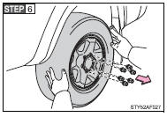 Remove all the wheel nuts and the tire.