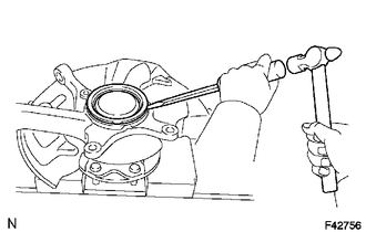 (a) Using a screwdriver and hammer, remove the knuckle grease retainer cap.