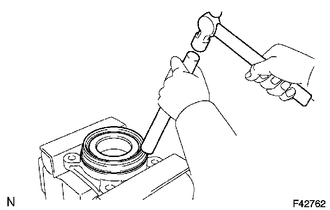 (a) Using a brass bar and a hammer, install a new front axle hub oil seal.