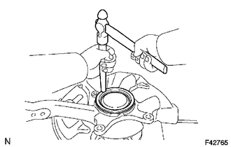 (a) Using a brass bar and a hammer, install a new knuckle grease retainer cap.